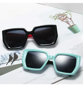 Chic square oversized sunglasses in classic black and mint green on a fashion magazine