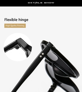 Detail view of the flexible metal hinge on durable black thick-framed resin sunglasses