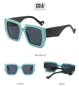 Detail view of square sunglasses with mint green frames, black temples and teardrop cutouts