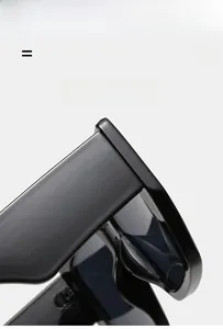 Detail of square black oversized sunglasses showing durable hinges and matte frame texture
