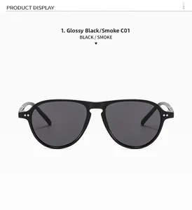 Detail of bright black pilot sunglasses frame featuring dual rivets and smoke gray lenses