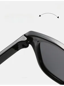 Detailed macro view of durable texture hinge on black glossy silicone kids sunglasses
