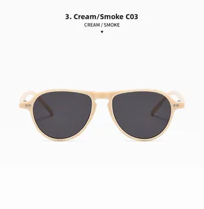 Detail shot of cream aviator sunglasses featuring smoke lenses and metal rivet accents