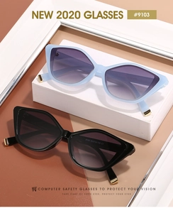 Detail of trendy cat-eye sunglasses with gradient lenses and stylish gold metal temple tips