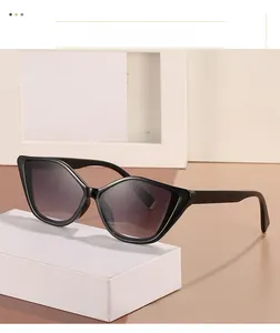 Close-up of trendy cat-eye sunglasses with black frame and gold metal details