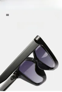 Detail of trendy black cat-eye sunglasses with super elastic frame and purple gradient lens