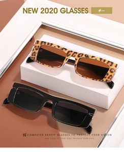Detail view of rectangular leopard print and black frame sunglasses on display