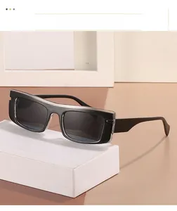 Detail of square sunglasses featuring double-layer transparent and black frames