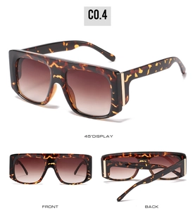 Detailed views of oversized tortoiseshell sunglasses with gradient lenses and gold accents