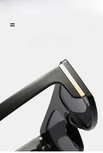 Detail of black oversized sunglasses with gold metal trim on lightweight elastic frame