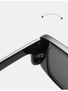 Close-up of durable metal hinge on black oversized sunglasses with frame details