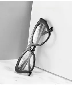 Detail of vintage cat-eye anti-blue light glasses with glossy black thick frame on marble