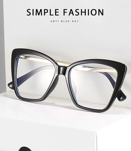Detail of black cat eye glasses frames with anti-blue light lens and gold metal accents