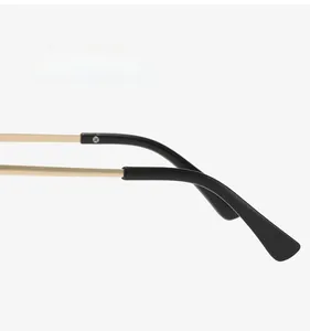 Macro detail of golden metal temples and black matte tips on cat-eye glasses