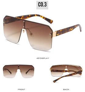 Detail view of oversized square sunglasses with gradient brown lenses and rivets