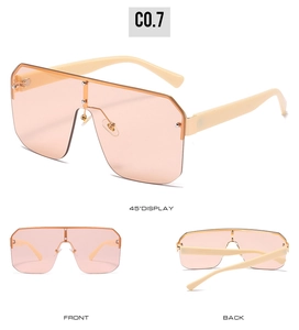 Three angles of orange-pink oversized shield sunglasses with ivory frame and rivets