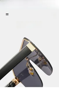 Detail of lightweight oversized shield sunglasses featuring golden hinges and elastic frame