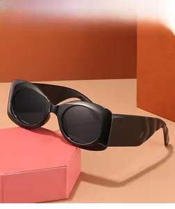 Detail of high-gloss thick black frame and dark grey lenses on geometric stand