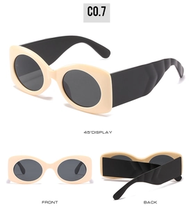 Detail view of oval beige sunglasses with wide wave-textured black temples and C0.7 code