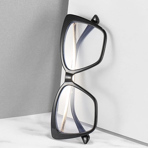 Retro black cat-eye glasses frame with blue light blocking lenses on marble surface