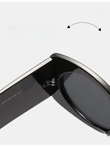 Detail of high-quality metal hinge and inner arm specifications on black oval sunglasses
