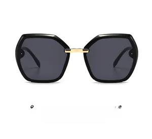 Detailed view of oversized geometric sunglasses with black frame and golden metal bridge