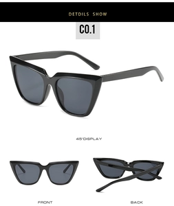Three-angle display of black oversized cat eye sunglasses with grey lenses in C0.1