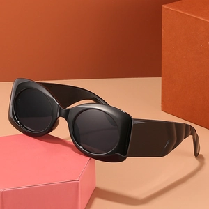 Retro black oval thick frame sunglasses with wide temples on artistic geometric background