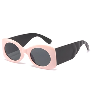 Retro oval sunglasses with jelly pink thick frame and wide black temples on white background