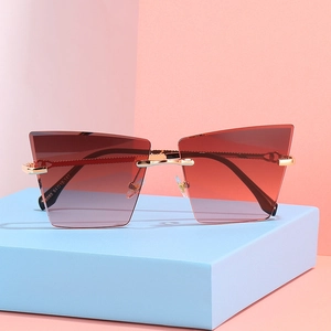 Lunettes de soleil œil de chat sans monture, verres dégradés marron et branches métalliques