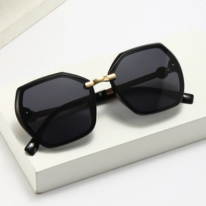 Fashionable oversized square sunglasses with black frame and gold metal accents