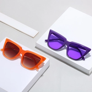 Stylish oversized cat eye sunglasses in vibrant orange and purple colors with gradient lenses
