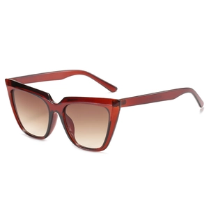 Women's cat eye sunglasses with oversized amber frames and brown gradient lenses