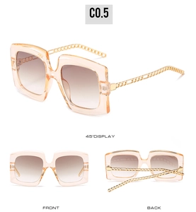 Detail of champagne square sunglasses with gold chain temples and gradient brown lenses