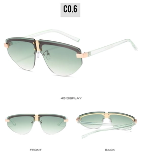 Detail view of rimless gradient green sunglasses with golden metal bridge and mint temples
