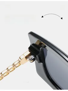 Detail of durable gold metal hinge on black square sunglasses with decorative chain
