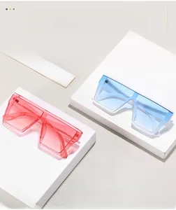 Detail of square oversized sunglasses with translucent pink and blue frames on display