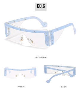 Detail view of light blue denim texture sunglasses with metallic studs and nose pads