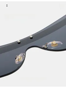 Detail of soft silicone nose pads and gold metal accents on rimless sunglasses
