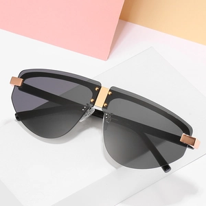 Frameless jelly-color aviator sunglasses with gold metal rivets on a minimalist pedestal