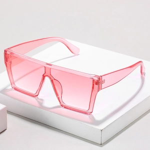 Classic oversized wrap-around sunglasses in transparent pink on a white podium