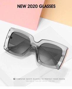 Detail view of square sunglasses with grey frames and rose gold textured hinge accents