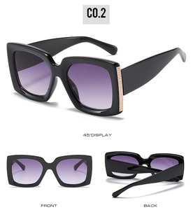 Detail view of square sunglasses with purple gradient lenses and gold mesh temple accents