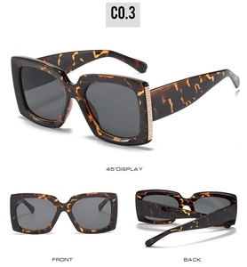 Detailed view of tortoise shell square sunglasses with gold mesh hinge accents