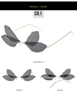 Detail view of dragonfly wing lenses with gold frames and clear bionic vein patterns