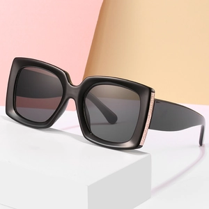 Square black sunglasses with thick frames and rose gold metal detail on wide temples