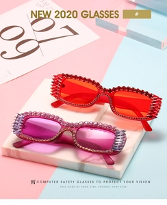 Detailed close-up of square sunglasses with colorful rhinestones and metal spike accents