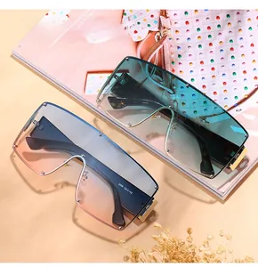 Detail of oversized shield sunglasses with gradient lenses and stylish metal rivets