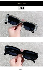 Close-up of black square sunglasses with crystal rhinestones on frames and temples