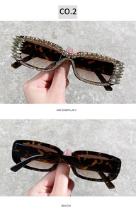 Detail view of tortoiseshell sunglasses with hand-set rhinestones and spiked crystal accents